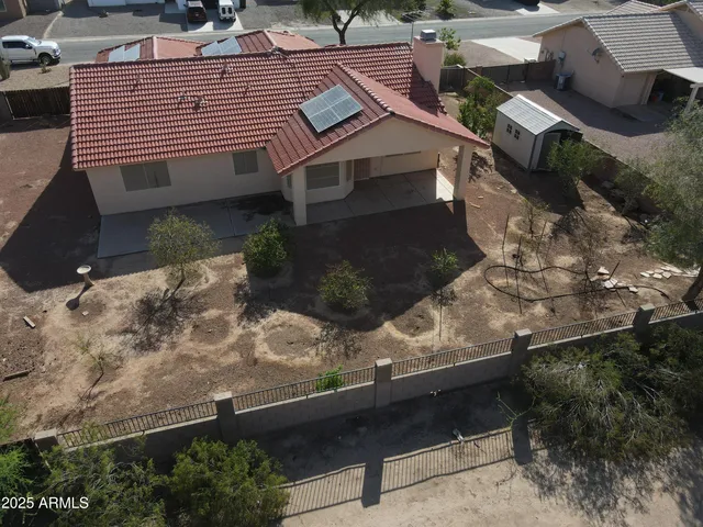 an aerial view of a house with a yard