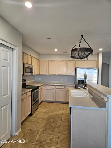 a kitchen with stainless steel appliances granite countertop a sink and stove top oven