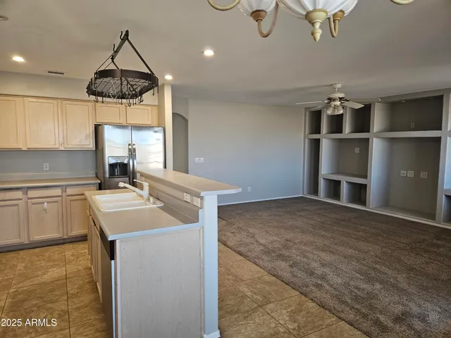 a kitchen with a sink appliances and cabinets