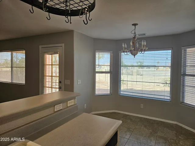 a room with chandelier and window