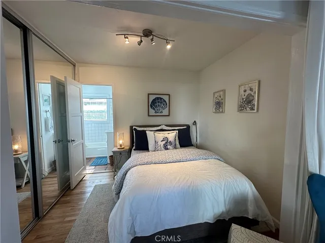 a view of a hallway with wooden floor and a hallway