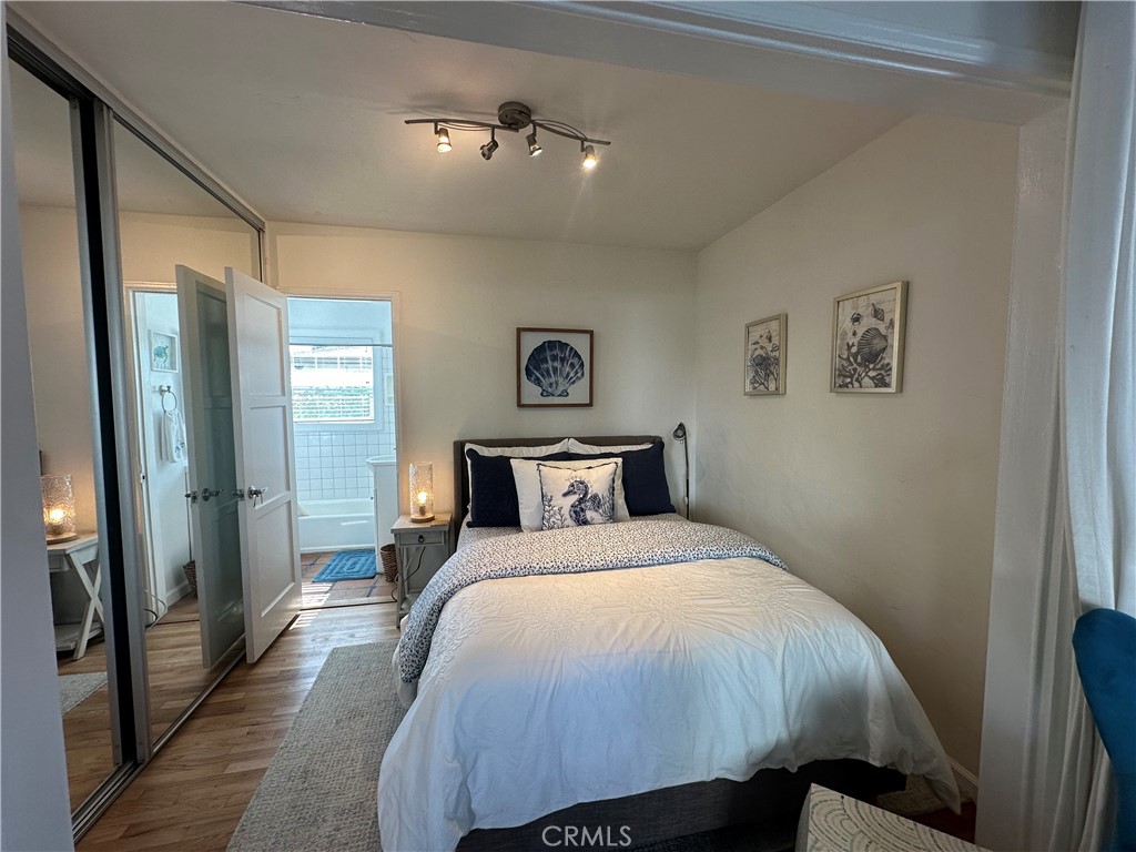 116 Avenida Serra, Unit 4 San Clemente, CA 92672 - Photo 15 of 23 a bedroom with a bed and a painting on the wall