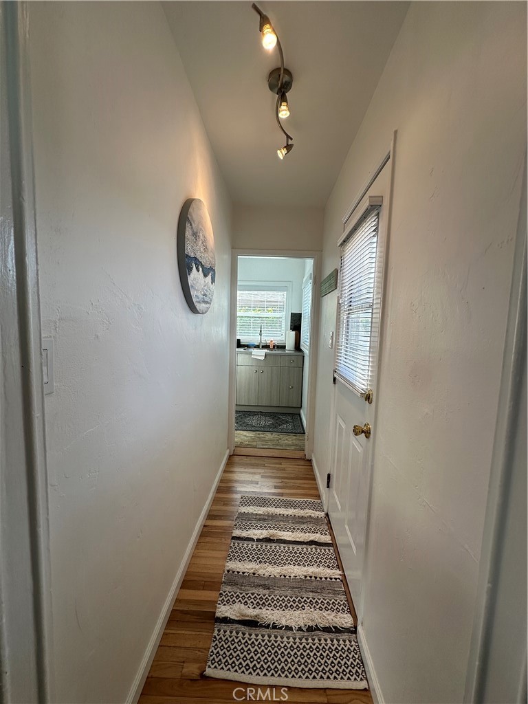 116 Avenida Serra, Unit 4 San Clemente, CA 92672 - Photo 16 of 23 a view of a hallway with wooden floor and a hallway