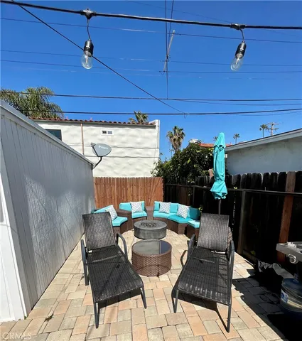 a view of a patio with table and chairs
