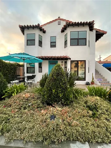 a patio with a table and chairs under an umbrella