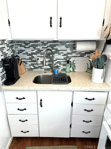 a kitchen with a sink and a stove
