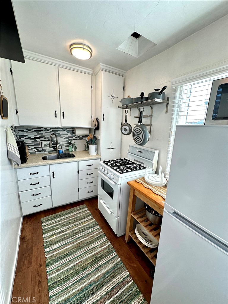 116 Avenida Serra, Unit 4 San Clemente, CA 92672 - Photo 7 of 23 a kitchen with stainless steel appliances granite countertop a stove and a sink