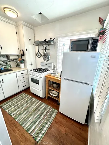 a kitchen with a stove a refrigerator and a stove