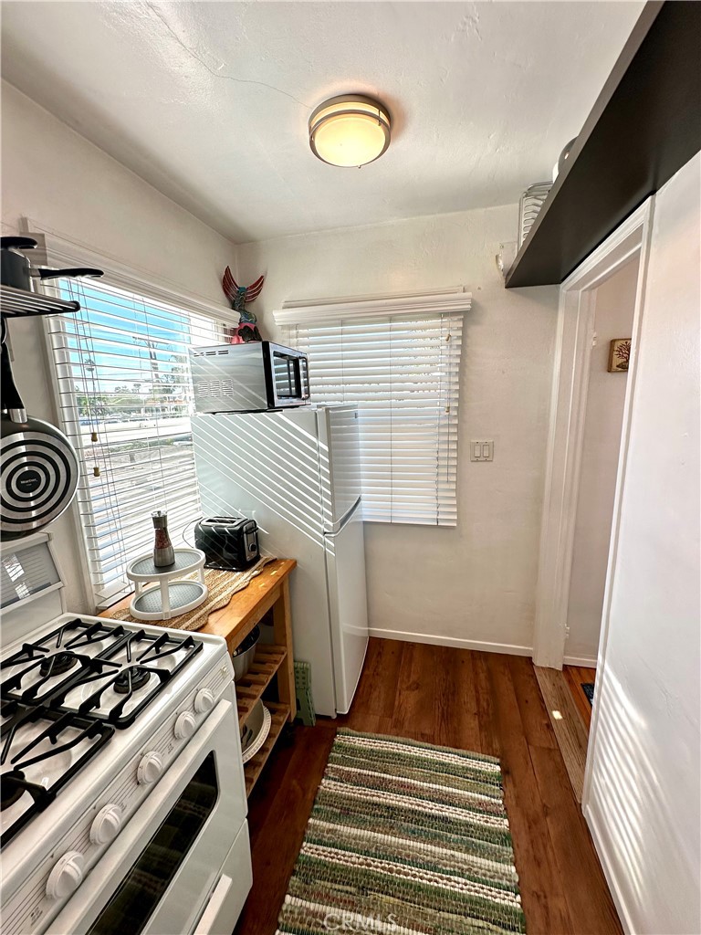 116 Avenida Serra, Unit 4 San Clemente, CA 92672 - Photo 10 of 23 a kitchen with a stove and a window