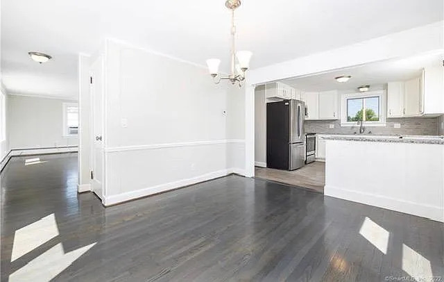 22 Fern Street Rocky Hill, CT 06067 - Photo 8 of 24 a view of a kitchen with a refrigerator and a stove top oven