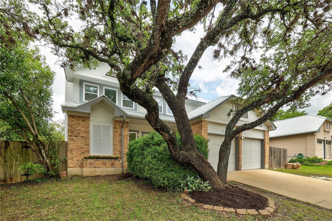 11812 Bittern Hollow Austin, TX 78758 - Photo 1 of 1 a front view of a house with a yard and garage