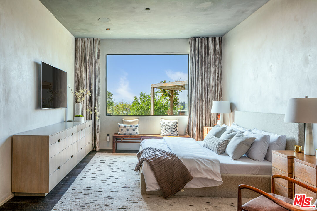 9152 Janice Place Beverly Hills, CA 90210 - Photo 12 of 18 a bedroom with a large bed and a flat tv screen on dresser