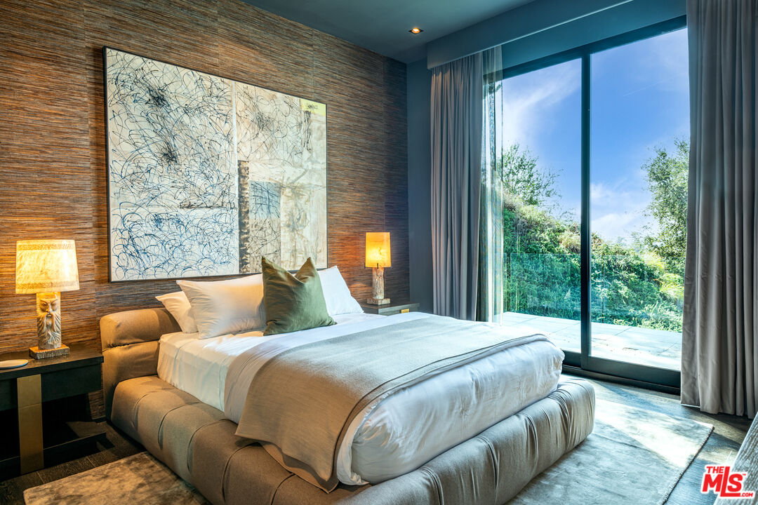 9152 Janice Place Beverly Hills, CA 90210 - Photo 13 of 18 a bedroom with a large bed and a large window