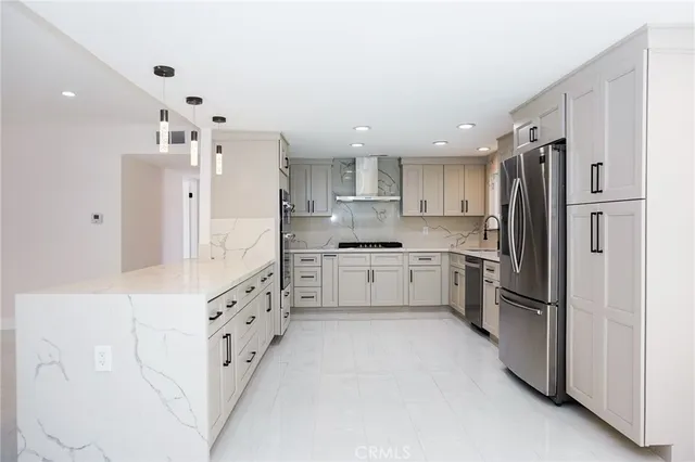 a kitchen with stainless steel appliances a refrigerator sink and cabinets