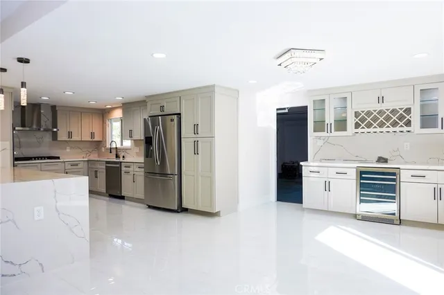 a kitchen with refrigerator a stove and cabinets