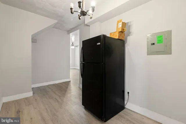 a view of a hallway with wooden floor and closet area