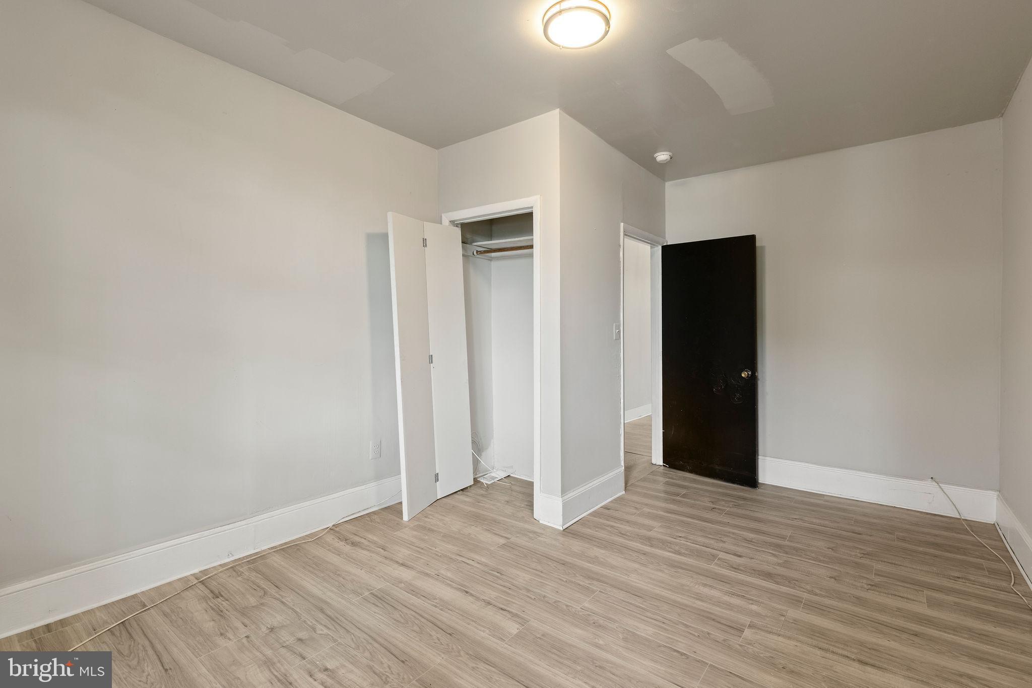 3003 Clifton Avenue Baltimore, MD 21216 - Photo 14 of 28 wooden floor in an empty room