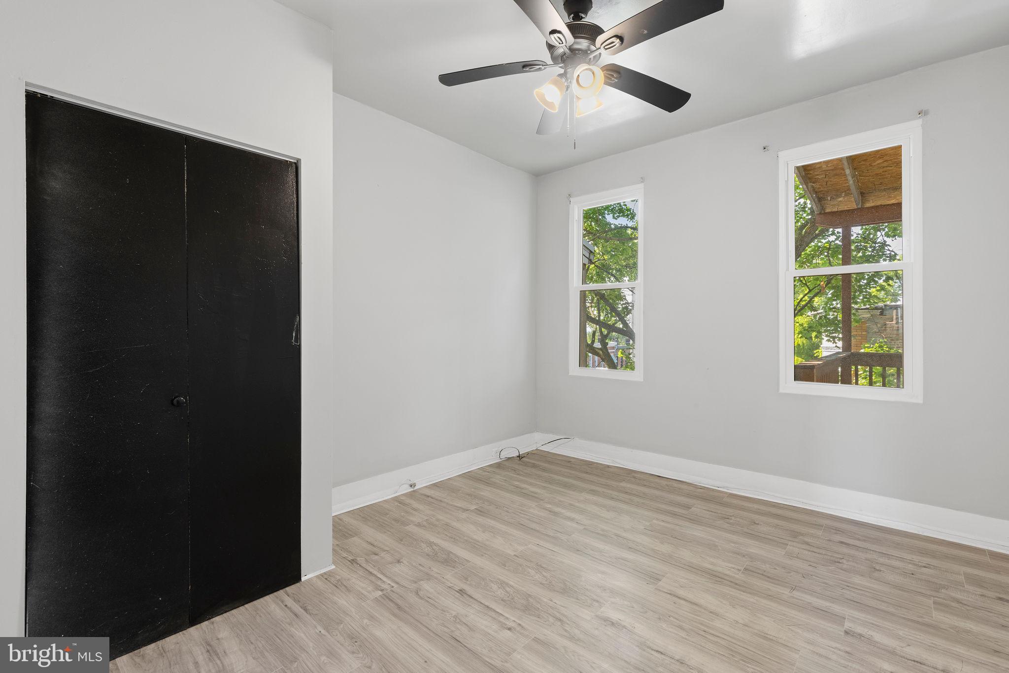 3003 Clifton Avenue Baltimore, MD 21216 - Photo 21 of 28 an empty room with wooden floor closet and windows