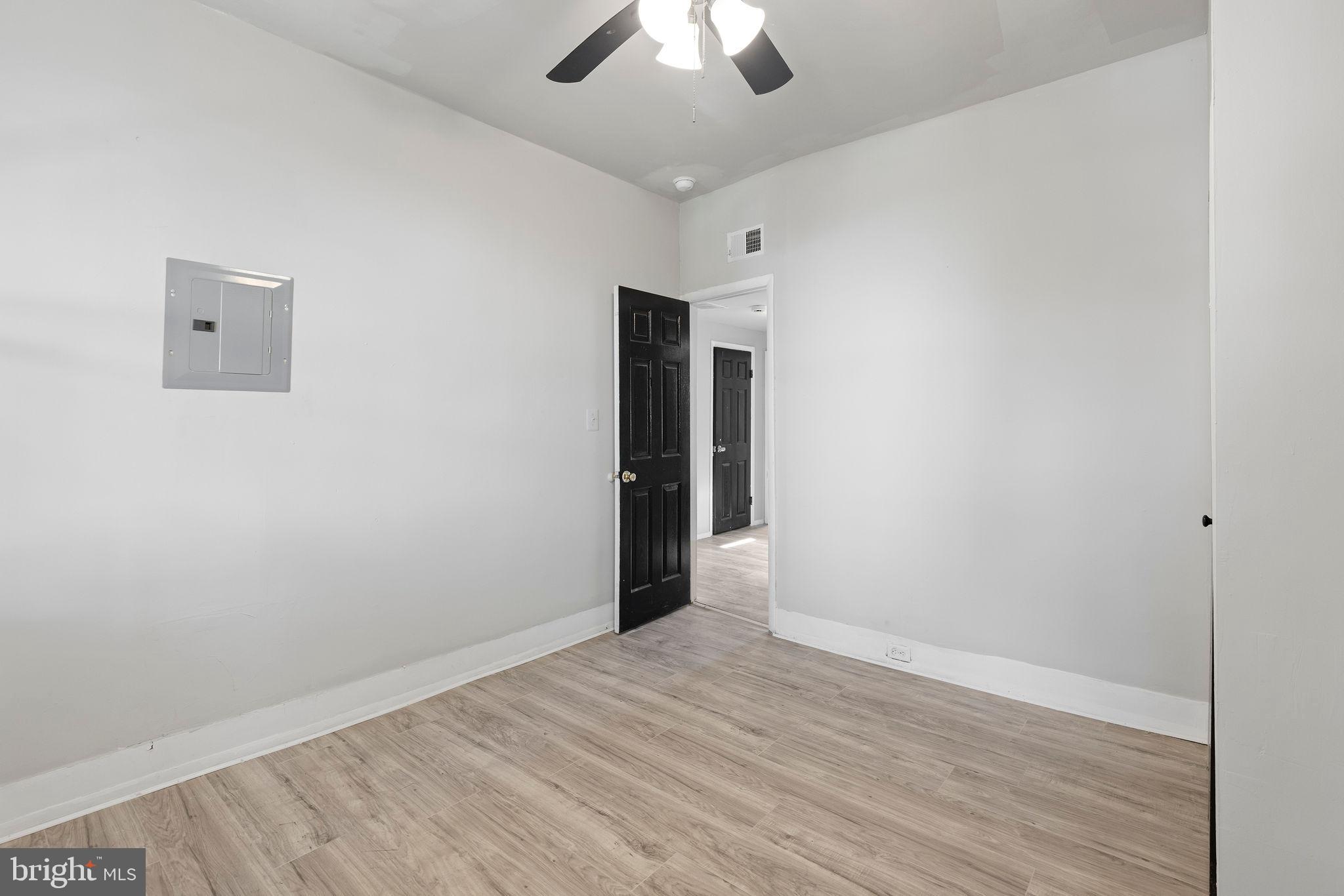 3003 Clifton Avenue Baltimore, MD 21216 - Photo 22 of 28 wooden floor in an empty room