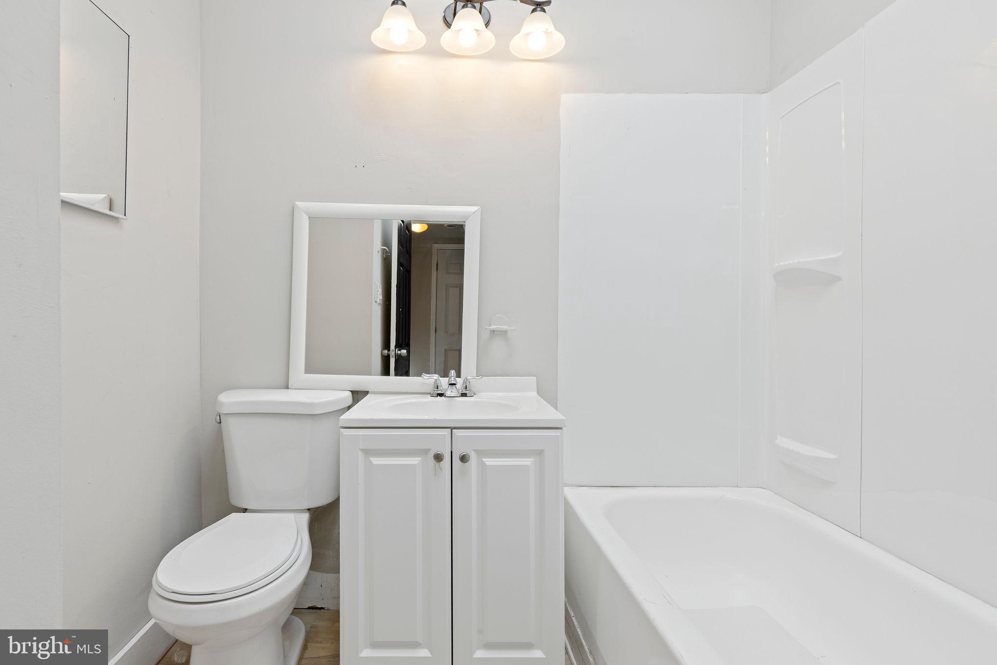 3003 Clifton Avenue Baltimore, MD 21216 - Photo 23 of 28 a bathroom with a sink a toilet and a bathtub