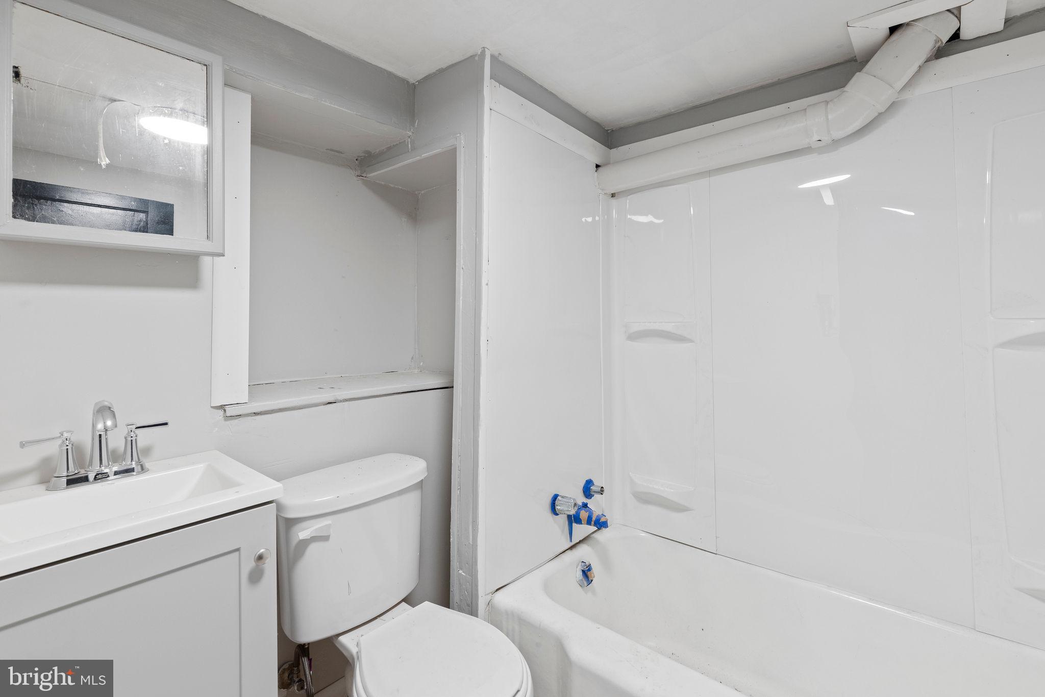 3003 Clifton Avenue Baltimore, MD 21216 - Photo 28 of 28 a bathroom with a sink toilet and vanity