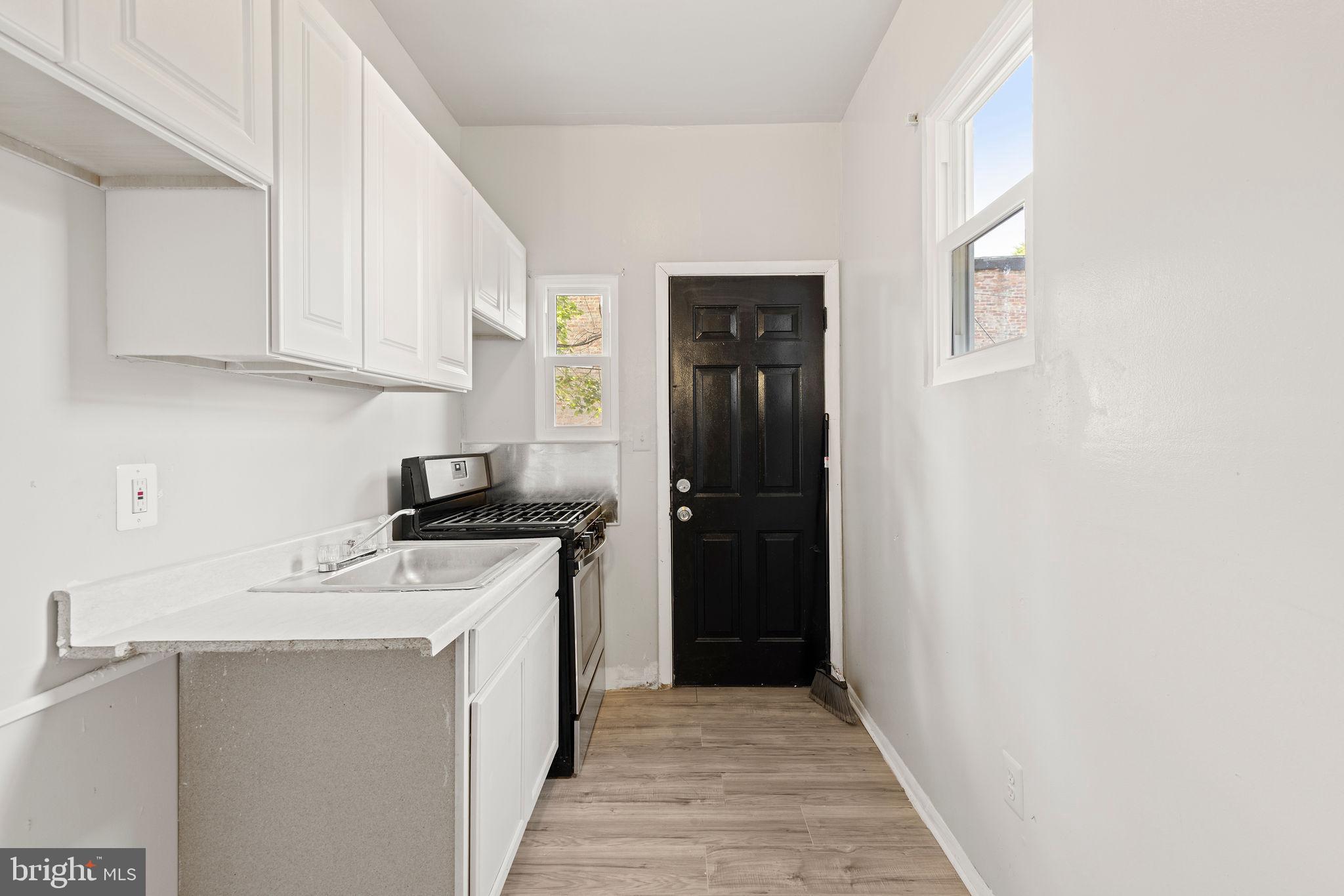 3003 Clifton Avenue Baltimore, MD 21216 - Photo 9 of 28 a kitchen with stainless steel appliances granite countertop a stove and a refrigerator
