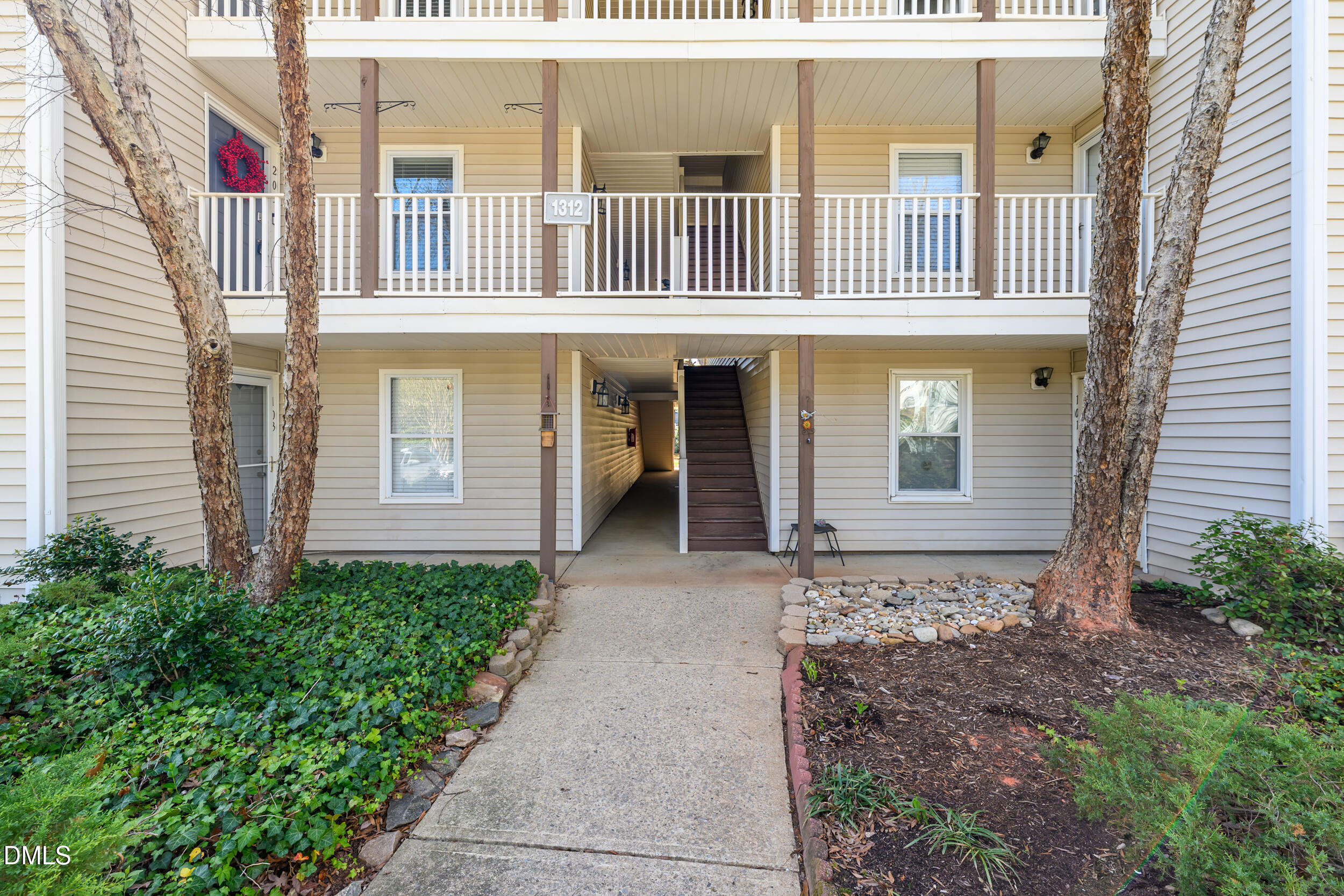 1312 Hillbrow Lane, Unit 203 Raleigh, NC 27615 - Photo 1 of 26 a front view of a house with a yard