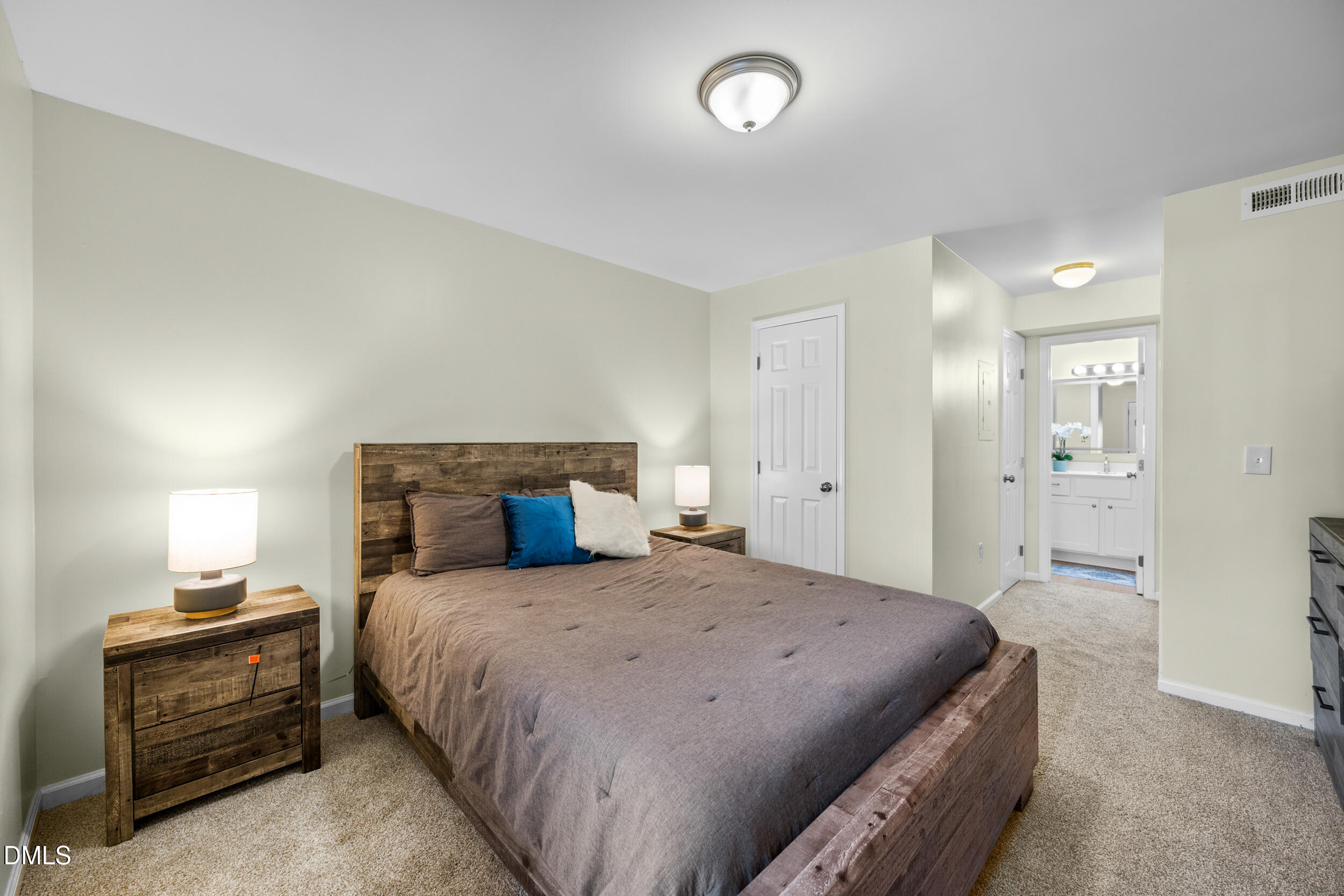 1312 Hillbrow Lane, Unit 203 Raleigh, NC 27615 - Photo 11 of 26 a bedroom with a bed and a dresser