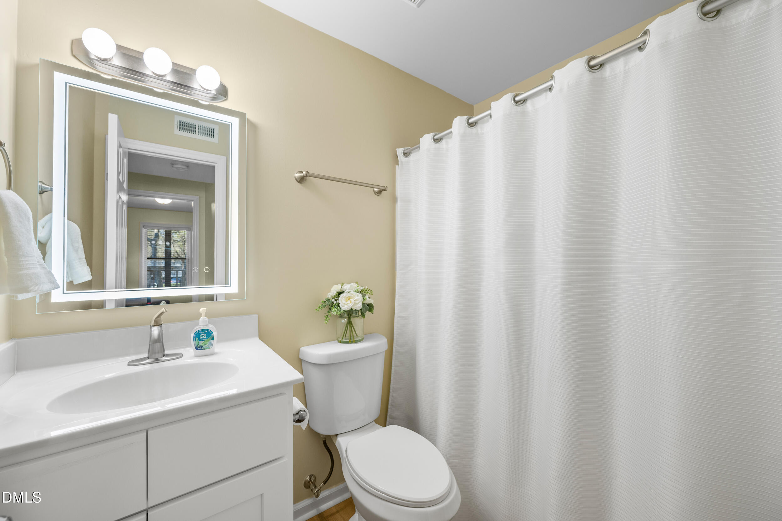 1312 Hillbrow Lane, Unit 203 Raleigh, NC 27615 - Photo 13 of 26 a bathroom with a sink a toilet and shower curtain
