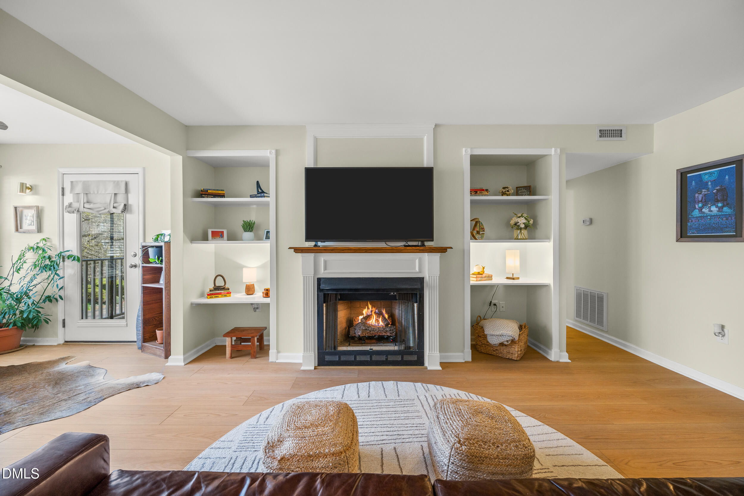 1312 Hillbrow Lane, Unit 203 Raleigh, NC 27615 - Photo 3 of 26 a living room with furniture and a fireplace