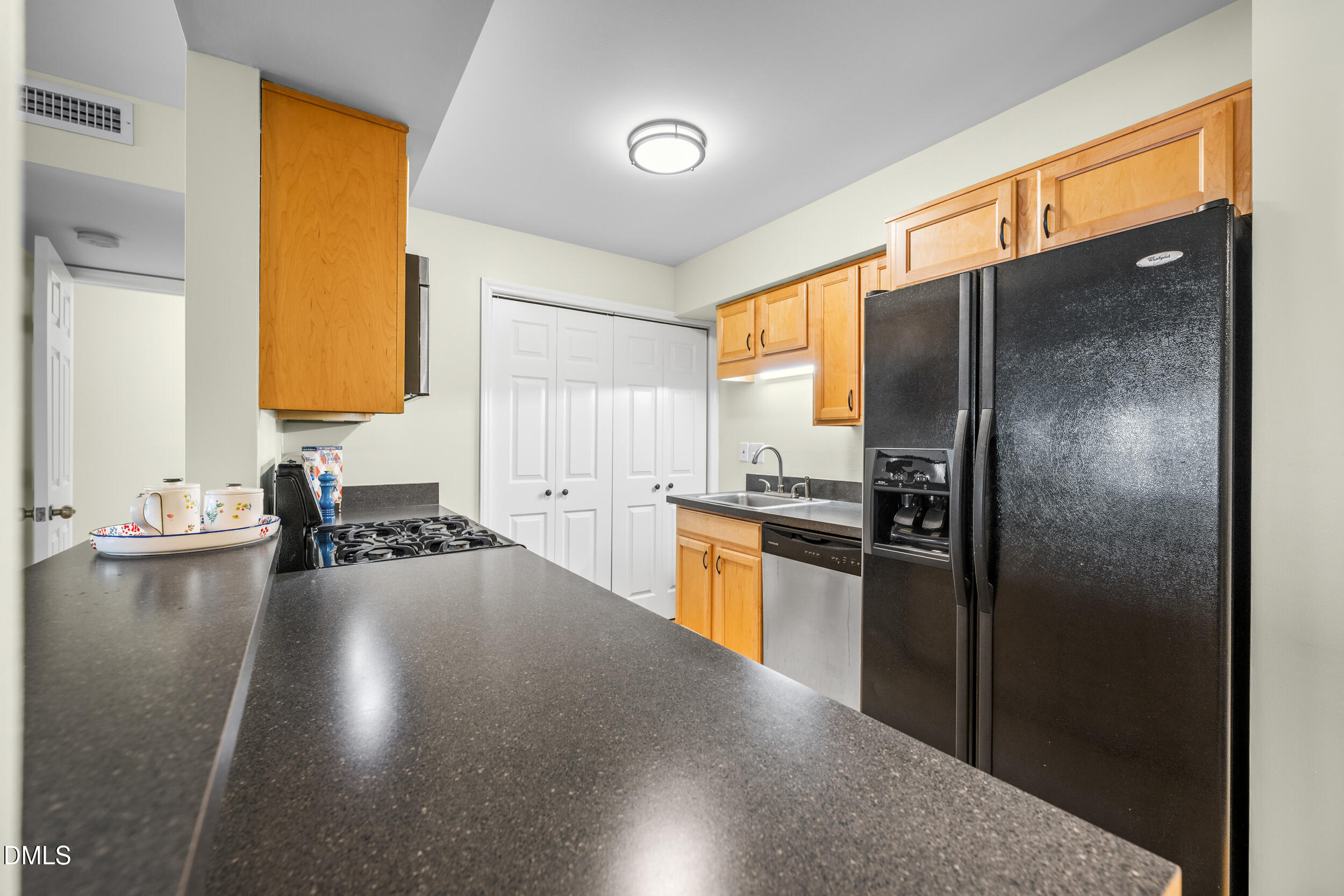 1312 Hillbrow Lane, Unit 203 Raleigh, NC 27615 - Photo 8 of 26 a kitchen with a refrigerator and a sink