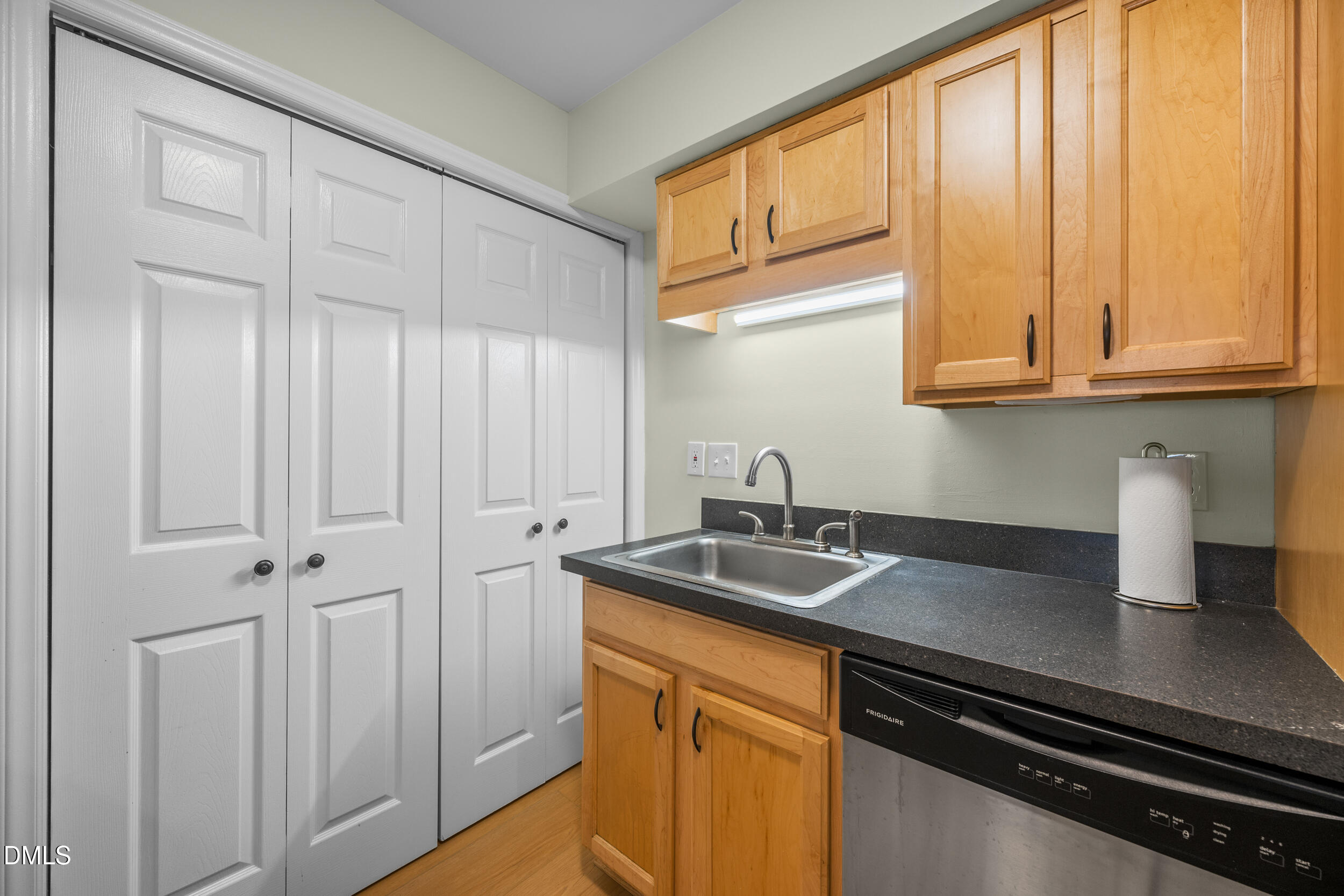 1312 Hillbrow Lane, Unit 203 Raleigh, NC 27615 - Photo 9 of 26 a kitchen with stainless steel appliances granite countertop white cabinets and a sink