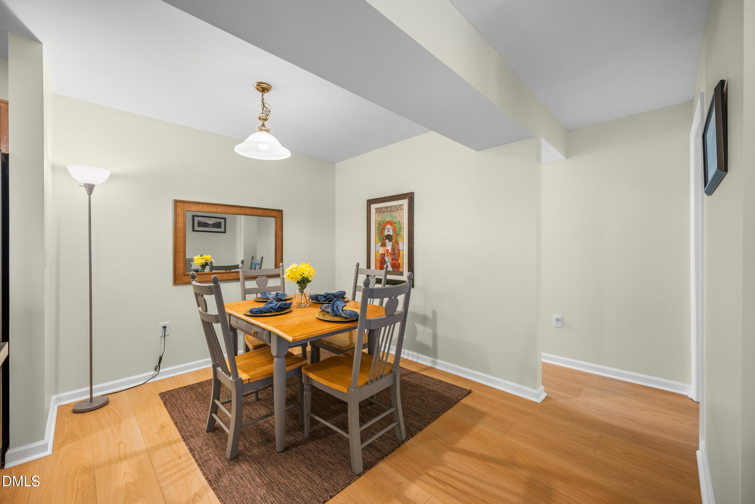 1312 Hillbrow Lane, Unit 203 Raleigh, NC 27615 - Photo 10 of 26 a view of a dining room with furniture and chandelier