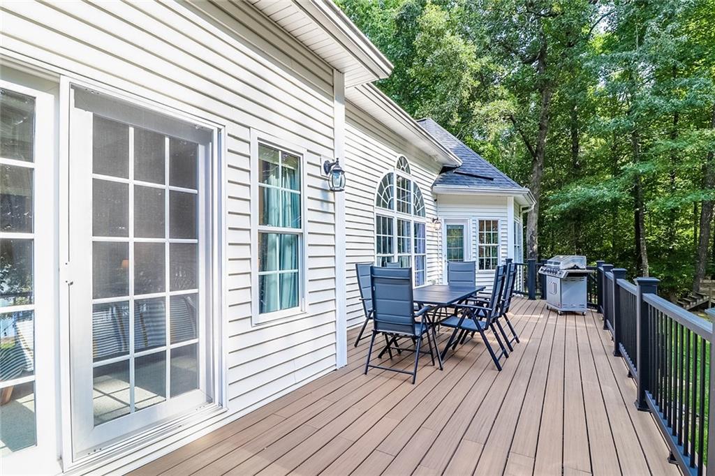 6150 Six Mile Cove Road Cumming, GA 30041 - Photo 20 of 27 a view of a house with wooden deck and furniture