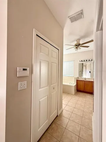 a bathroom with a tub and a view of bathroom