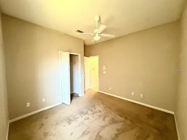 an empty room with a empty space and a ceiling fan