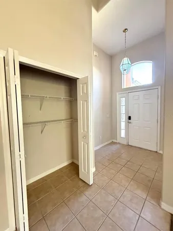 an empty room with closet and windows
