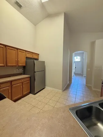 a kitchen with stainless steel appliances a sink and a refrigerator