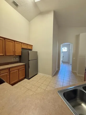 a kitchen with stainless steel appliances a sink and a refrigerator