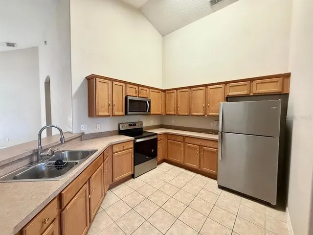a kitchen with a sink cabinets and appliances