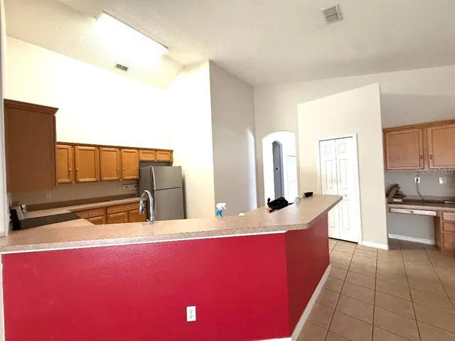 a kitchen with stainless steel appliances kitchen island granite countertop a sink and cabinets