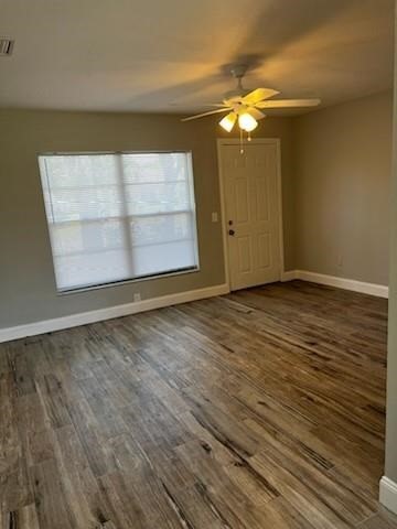 Undisclosed Address Sebastian, FL 32958 - Photo 3 of 14 an empty room with wooden floor cabinet and windows