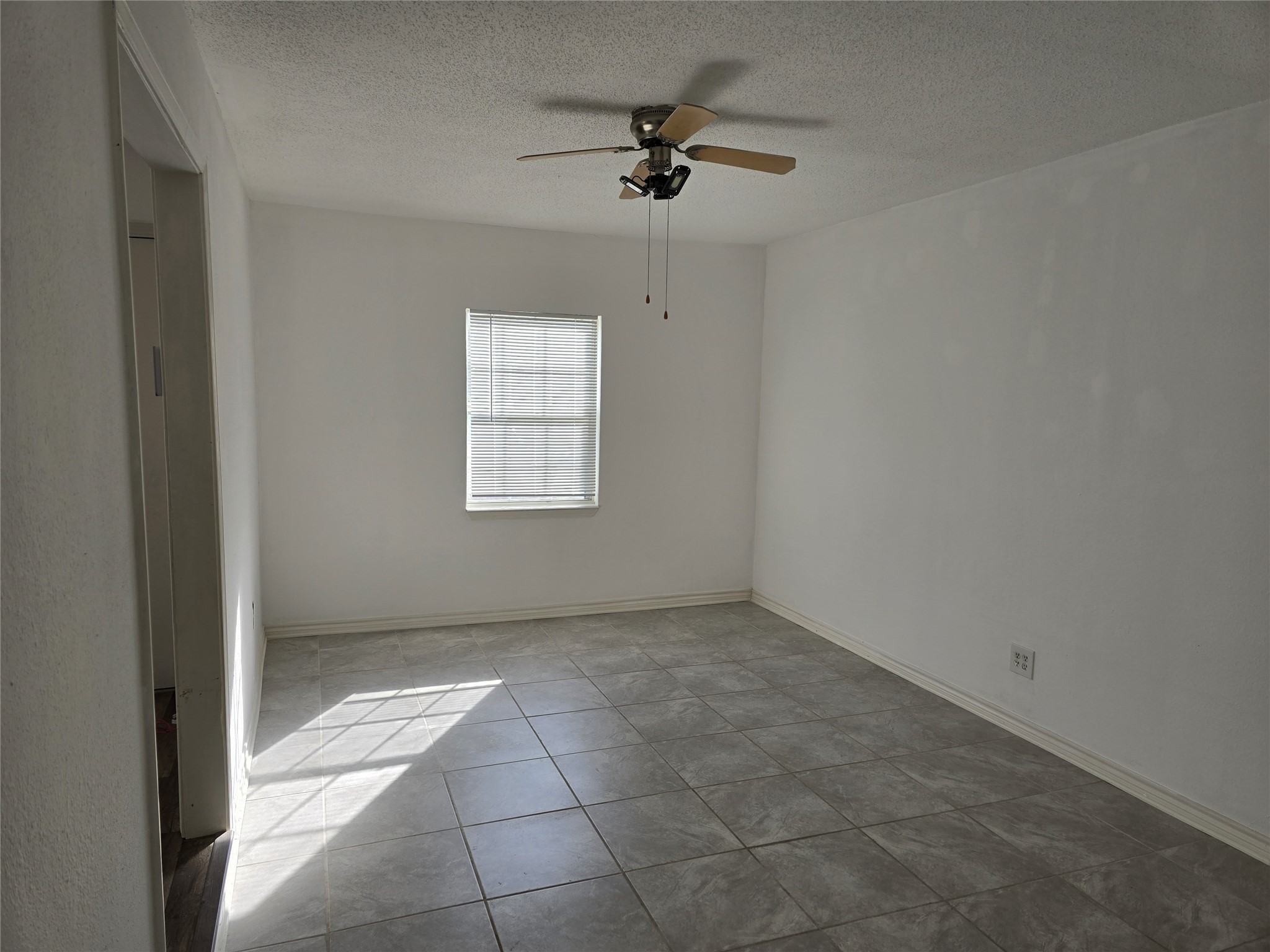 3619 Washington Street Pasadena, TX 77503 - Photo 11 of 16 an empty room with a ceiling fan and windows