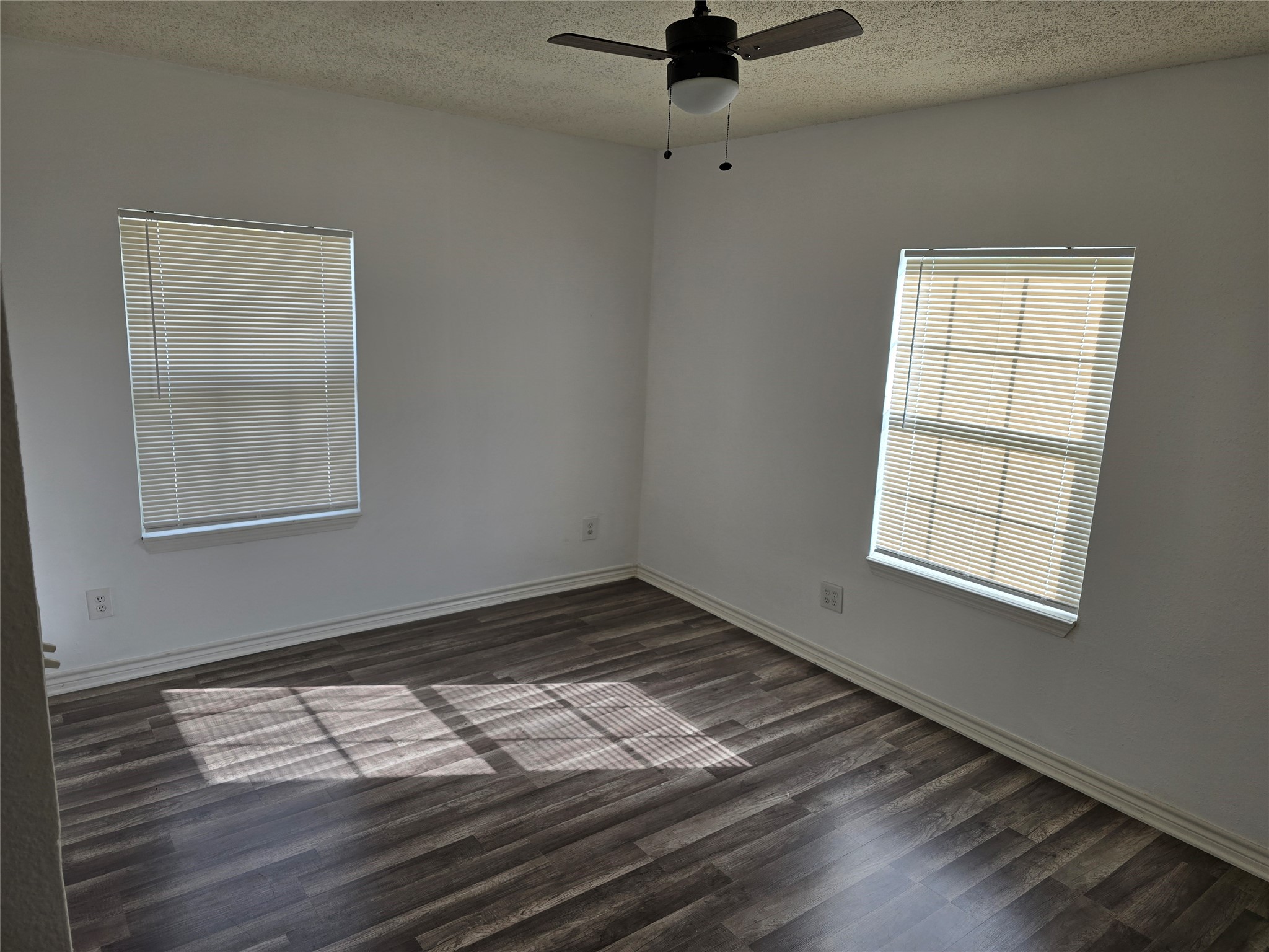 3619 Washington Street Pasadena, TX 77503 - Photo 4 of 16 an empty room with wooden floor cabinet and windows