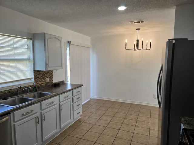 a kitchen with a refrigerator and a sink