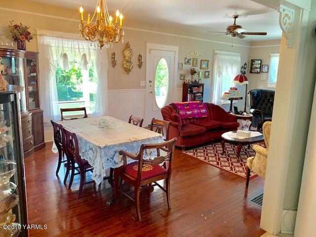 341 Heikle Road Wapato, WA 98951 - Photo 21 of 29 a view of a dining room with furniture window and wooden floor