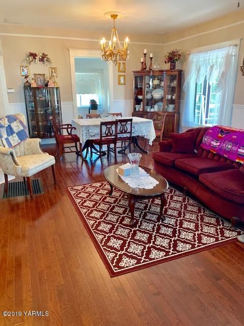 341 Heikle Road Wapato, WA 98951 - Photo 22 of 29 a living room with furniture a fireplace and a large window