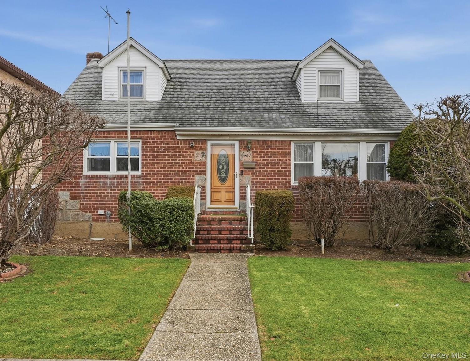 83-57 251st Street Queens, NY 11426 - Photo 13 of 14 a front view of a house with a yard