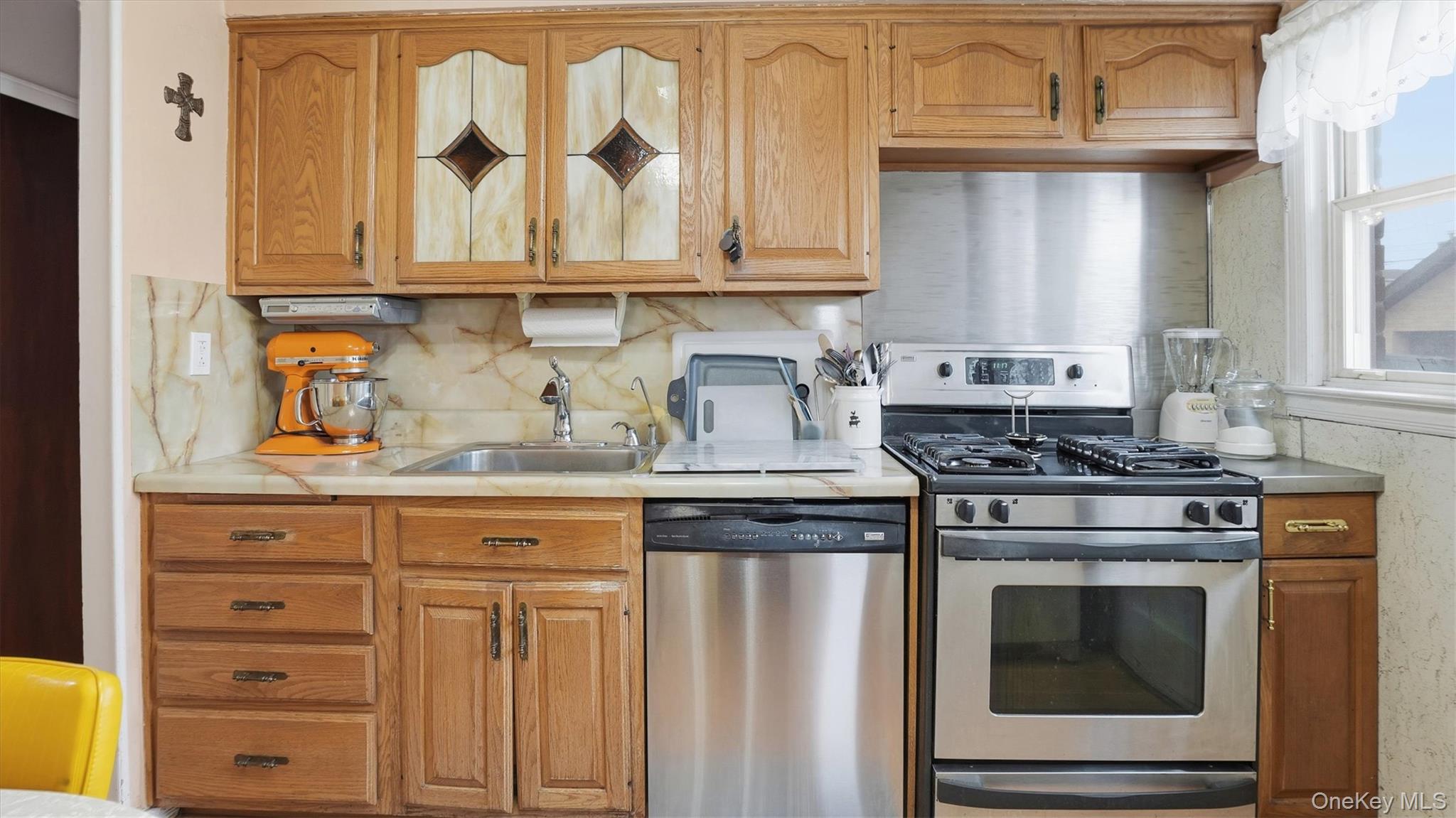 83-57 251st Street Queens, NY 11426 - Photo 6 of 14 a kitchen with granite countertop white cabinets and stainless steel appliances