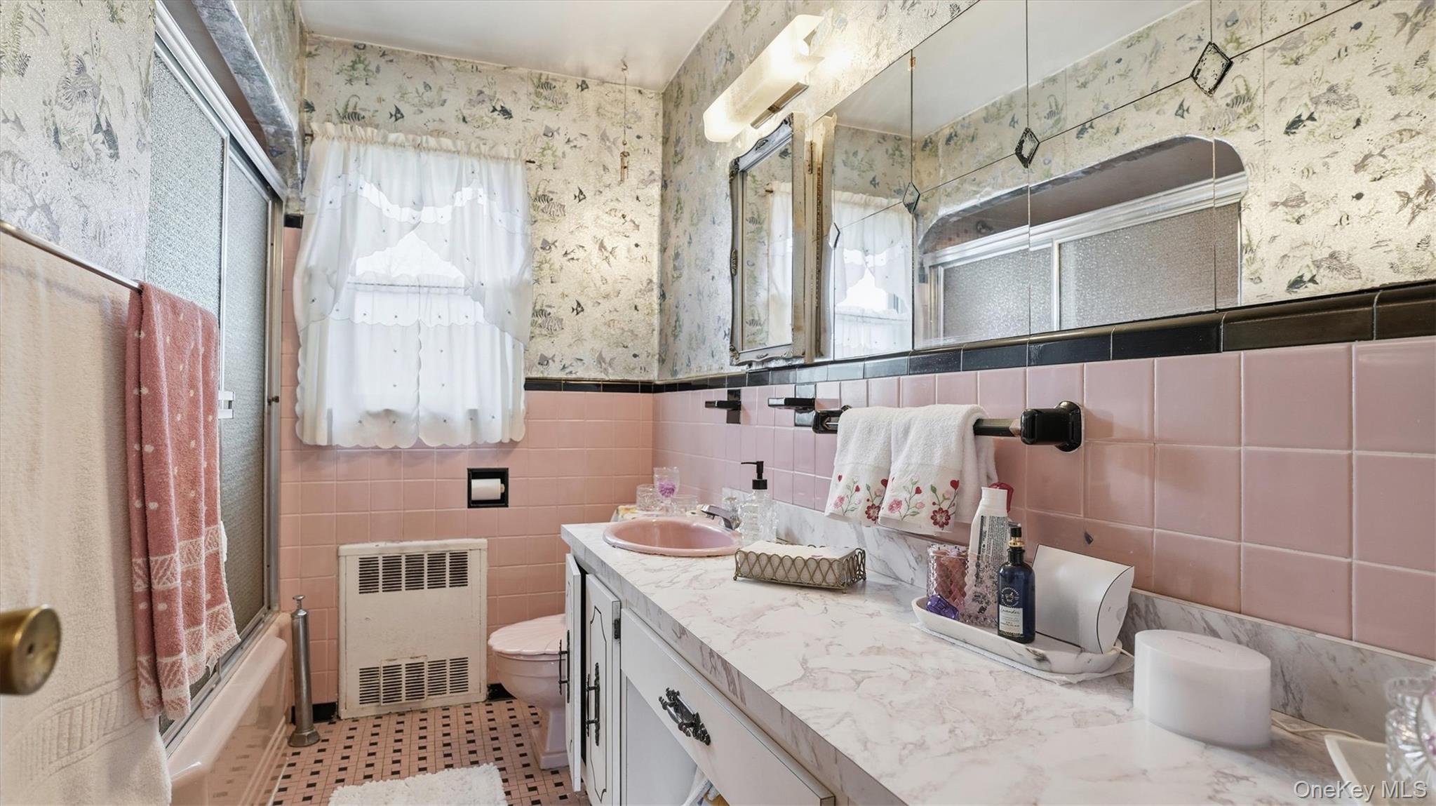 83-57 251st Street Queens, NY 11426 - Photo 7 of 14 a bathroom with a sink and a mirror